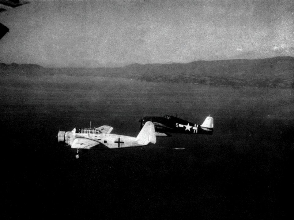 Grumman F6F-5 Hellcat of VF-40 escorts Japanese Kyūshū K11W after the Japanese surrender, in August 1945