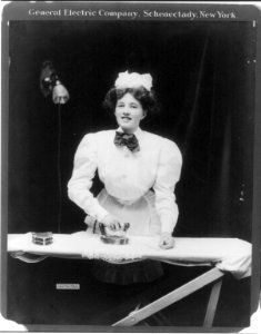 House maid ironing a lace doily with GE electric iron LCCN2004665710 photo