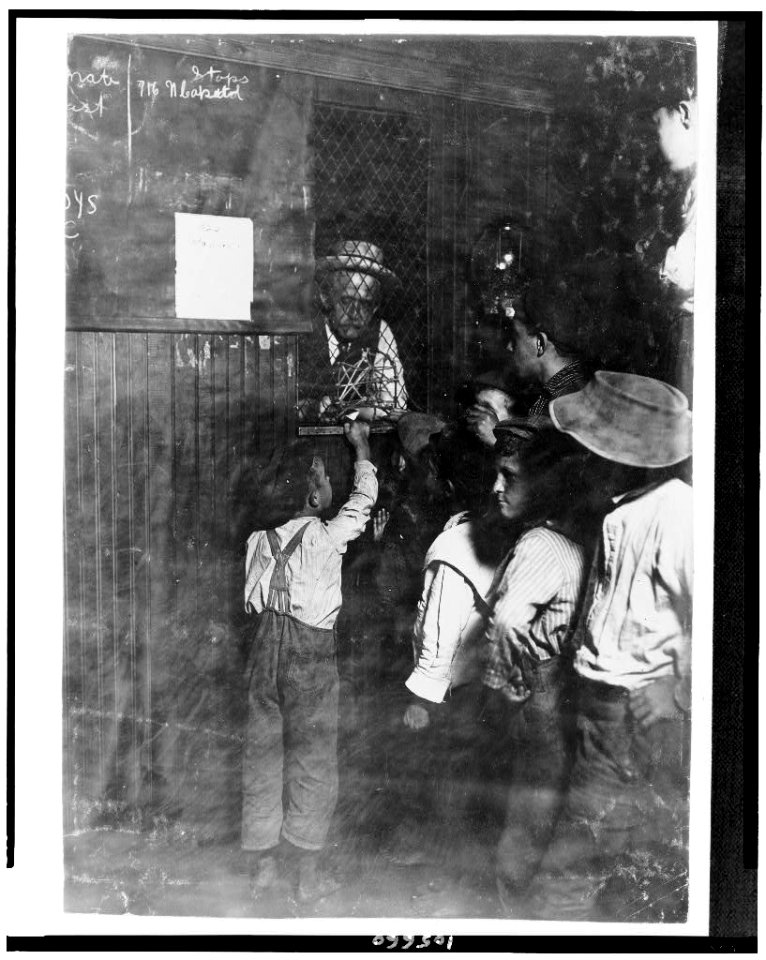 Indianapolis Newsboys buying brass checks in a newspaper office. These checks cost at the rate of one-half the selling price of the newspaper and are exchanged at another window for the LOC cph.3c05660