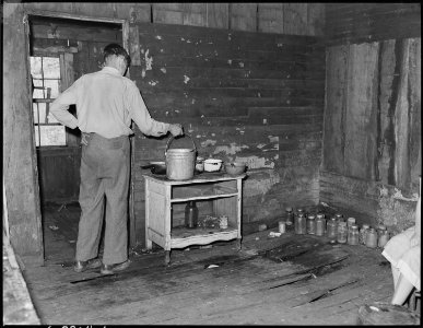 Jo King, miner and widower, who lives in this house for which he pays $3 monthly with his three children. Cary, Bell... - NARA - 541177