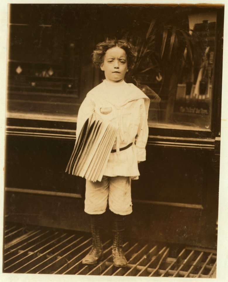 Jo. Lehman, a 7 year old newsboy. 824 Third Ave., N.Y. City. He was selling in this Saloon. I asked him about the badge he was wearing. 'Oh! Dat's me bruder's,' he said. LOC nclc.03684