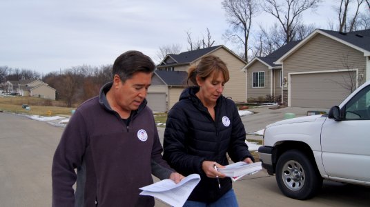 Joe Enriquez Henry with the League of United Latin American Citizens goes door-to-door to urge people to vote in Des Moines, Iowa
