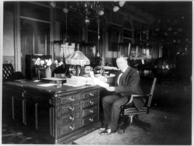 Josephus Daniels, full-length portrait, seated at desk, facing left LCCN89709647 photo