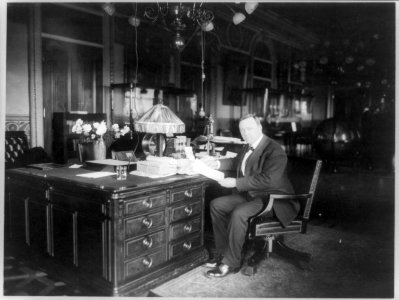Josephus Daniels, full-length portrait, seated at desk, facing left LCCN89709647