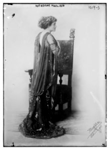 Katherine Kaelred standing before chair, Moffett Studio in Chicago - Moffett Studio LCCN2014684757