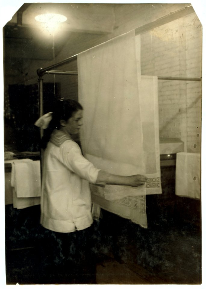 Katherine Flanagan, 15 years old. Examining curtains at Boutwell, Fairclough & Gold, 274 Summer Street Extension. Mr. Fitzgerald, Manager. LOC nclc.05189