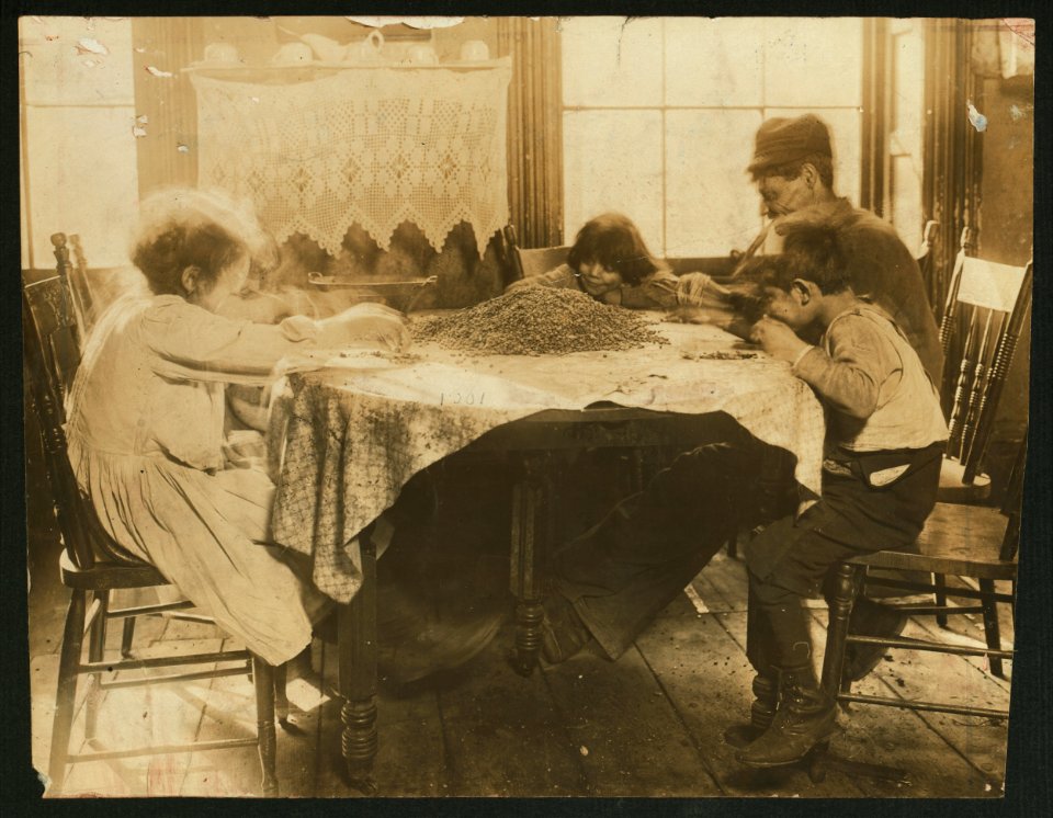 Left to right- Florence Lieto, 10 years old. Jennie Macola, 10 years old (hidden) Mamie Macola, 8 years old. Nicholas Macola, 6 years old. Picking coffee sweepings. The sweepings cost 25 LOC nclc.05454