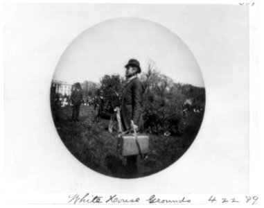 Man with suitcase and others on the White House grounds LCCN2002723174