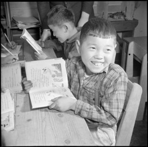 Manzanar Relocation Center, Manzanar, California. A pupil of the third grade is taught to read and . . . - NARA - 536698