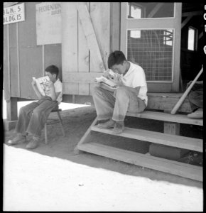Manzanar Relocation Center, Manzanar, California. Evacuee boys of Japanese ancestry at entrance of . . . - NARA - 538075