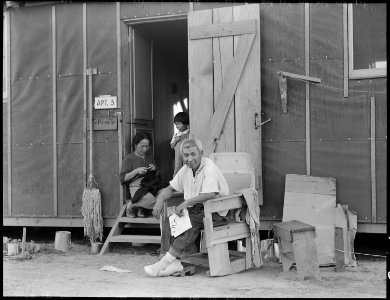 Manzanar Relocation Center, Manzanar, California. Evacuees family of Japanese ancestry relax in fro . . . - NARA - 537989