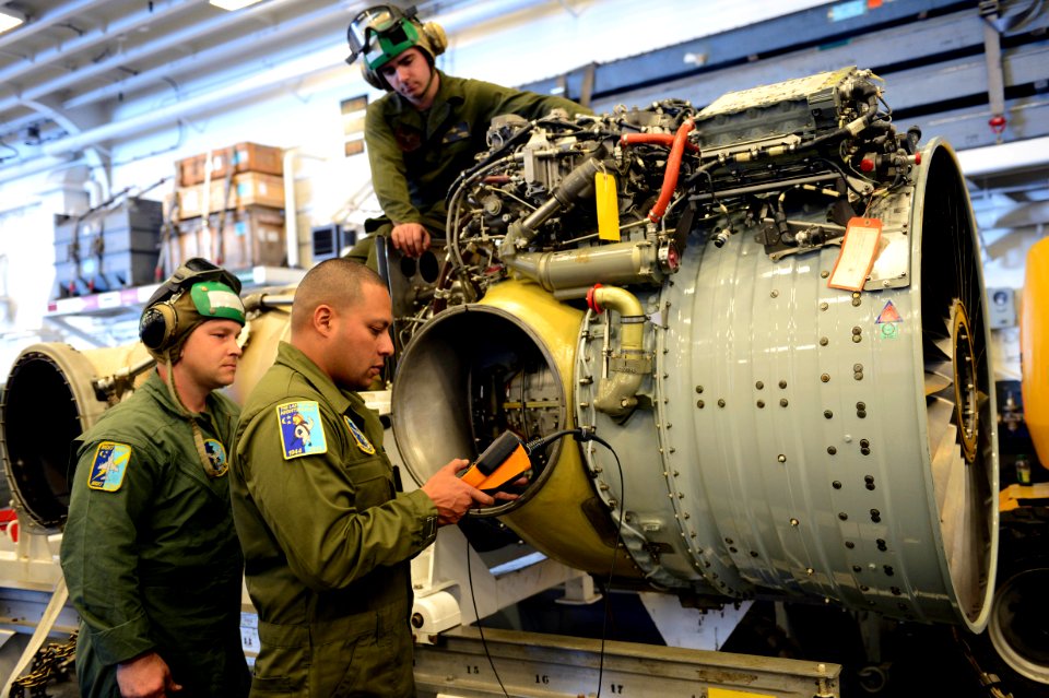 Marines examine an AV-8B engine at sea. (8456178520)