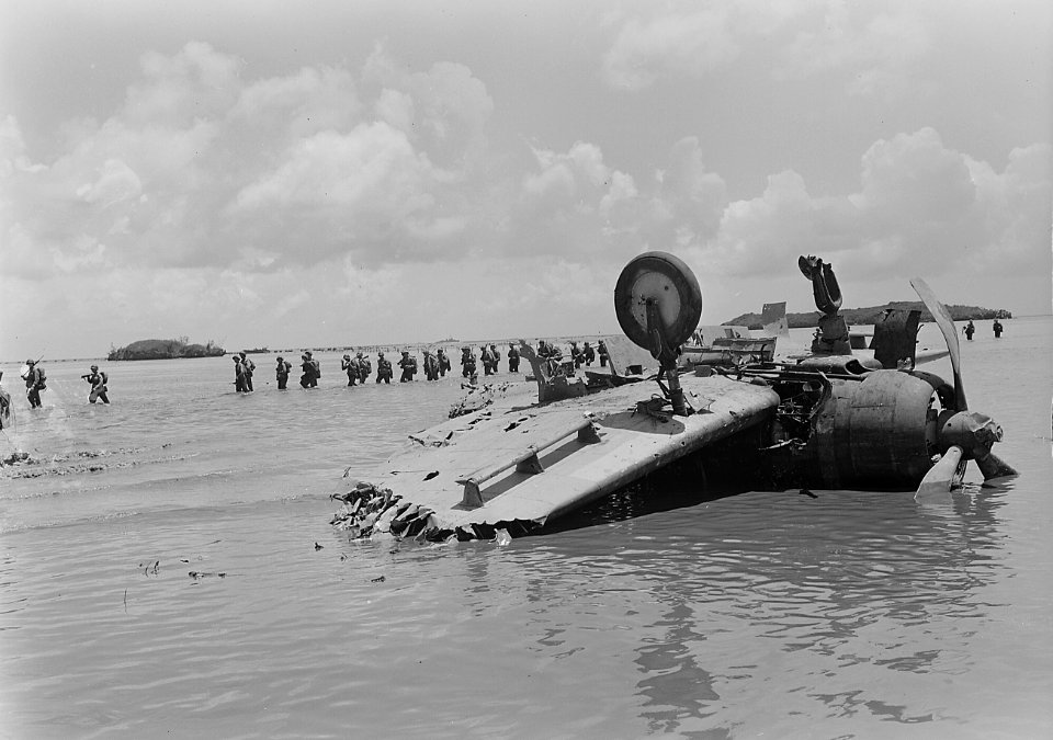 Marines move past wrecked Jap dive bomber on way to Agat beach on Guam. - NARA - 520965 (cropped)