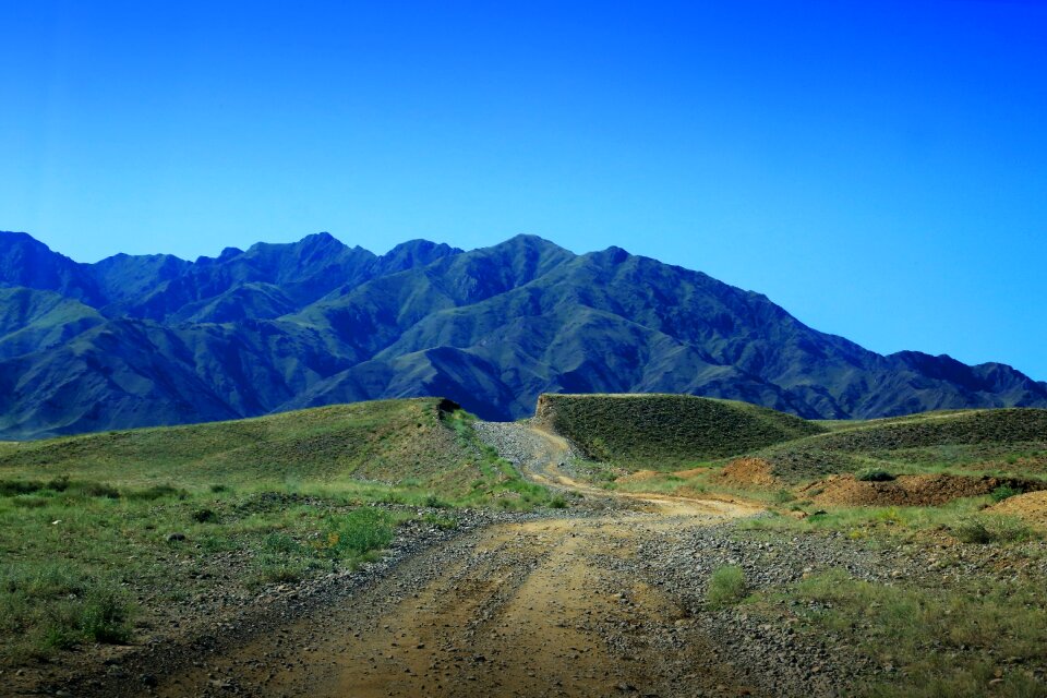 The dirt road mountain blue sky