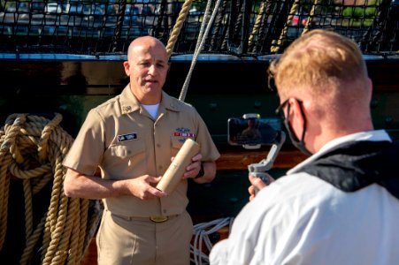 Master Chief Petty Officer of the Navy (MCPON) Russell Smith dedicates a round during a 21-gun salute onboard USS Constitution 211013-N-KN686-0283