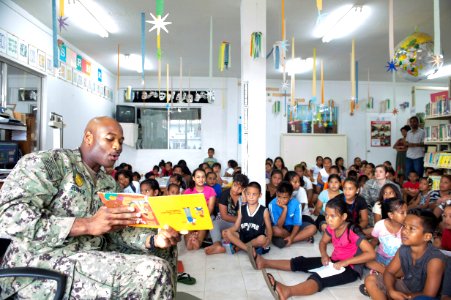 Master-at-Arms 1st Class Charles Runner reads a book to children. (19143218682)
