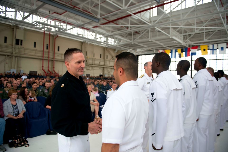 Master Chief Petty Officer of the U.S. Navy Mike Stevens, foreground left, congratulates reenlisted Sailors at an all-hands call at Naval Air Station Jacksonville, Fla., May 3, 2013 130503-N-WL435-856