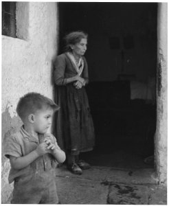 Matera, Italy. Still unaware of despair, a small boy of Matera, Italy, unconsciously repeats the gesture of his... - NARA - 541739 photo