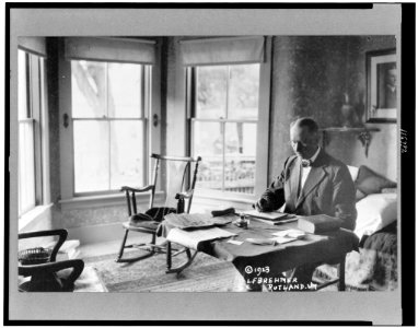 President Calvin Coolidge, half-length portrait, seated at desk in family home in Rutland, Vt. LCCN96520616 photo