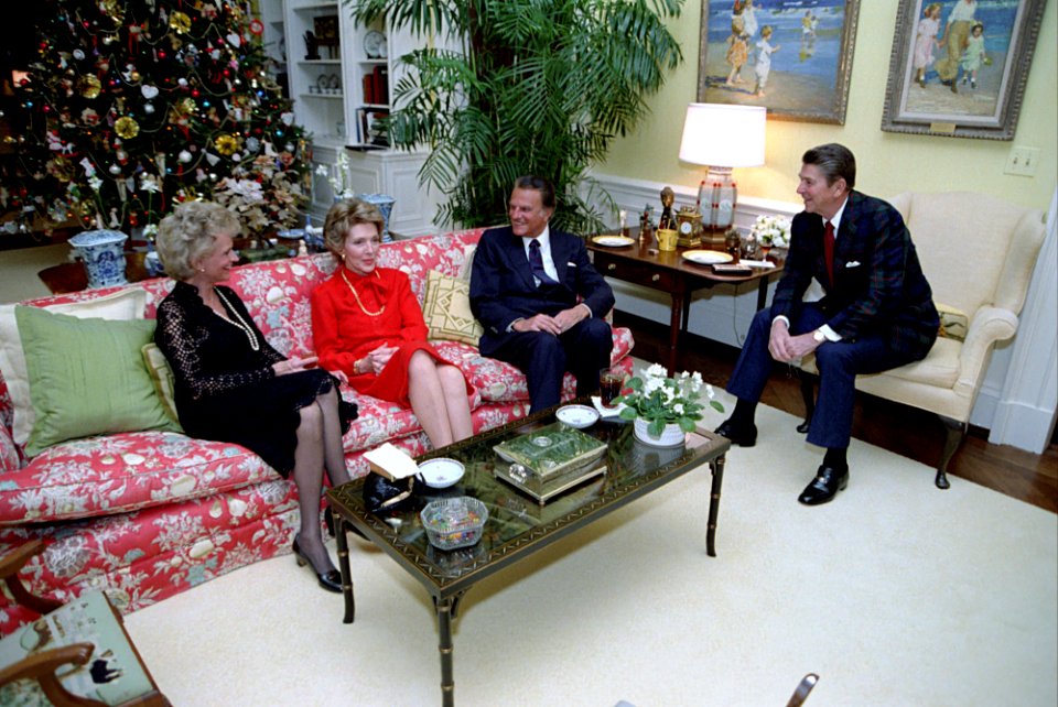 President Ronald Reagan during a dinner with Billy Graham and Mrs. Graham in the Residence
