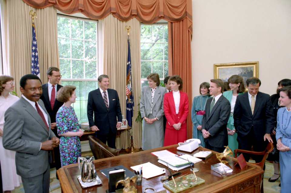 President Ronald Reagan during a photo opportunity with staff members of the Office of Public Liaison in the Oval Office