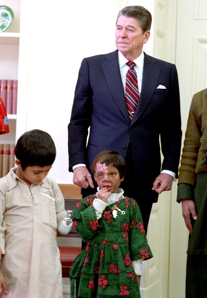 President Ronald Reagan during a photo op with Afghan children being treated in the United States