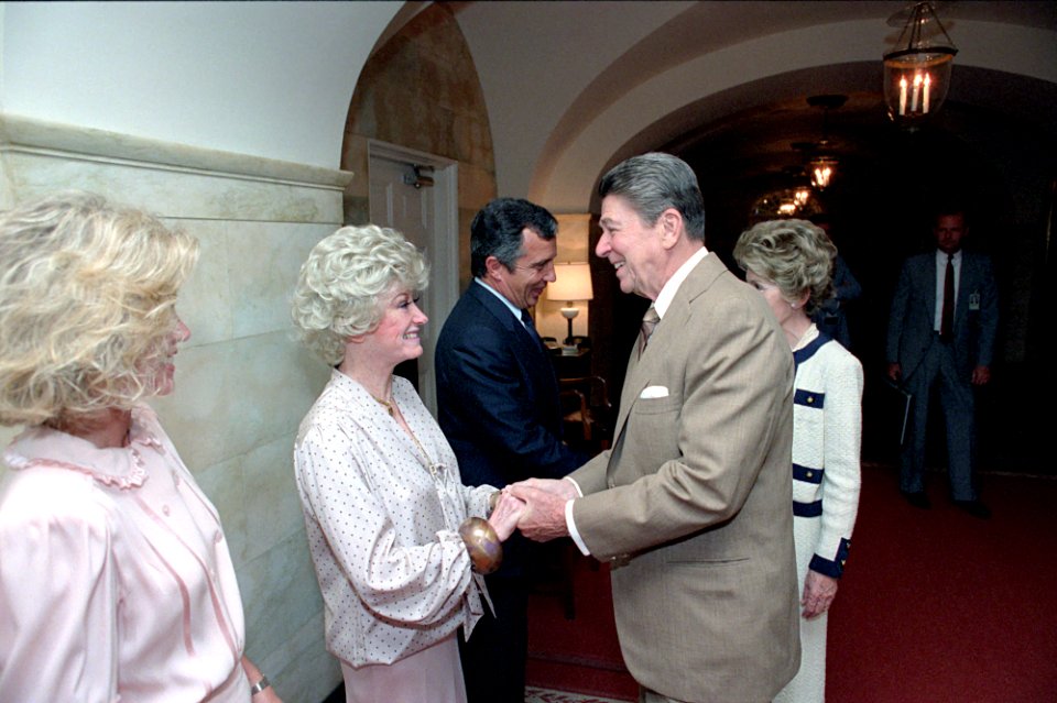 President Ronald Reagan greeting comedian Phyllis Diller with Donna Mills
