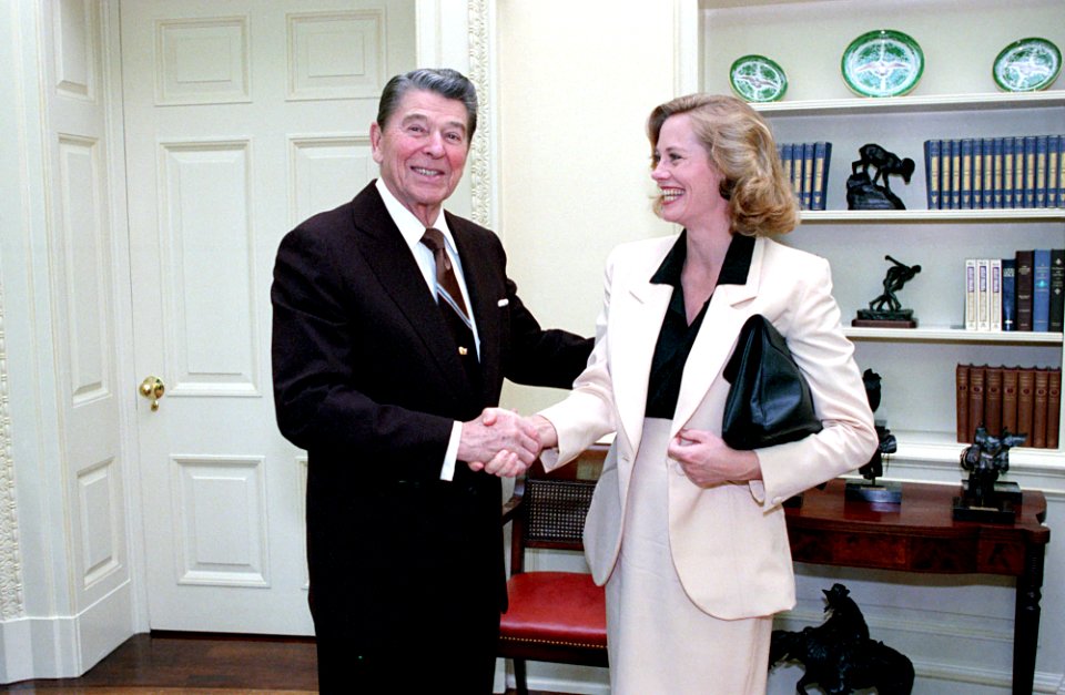 President Ronald Reagan greeting actress Cybill Shepherd in the Oval Office