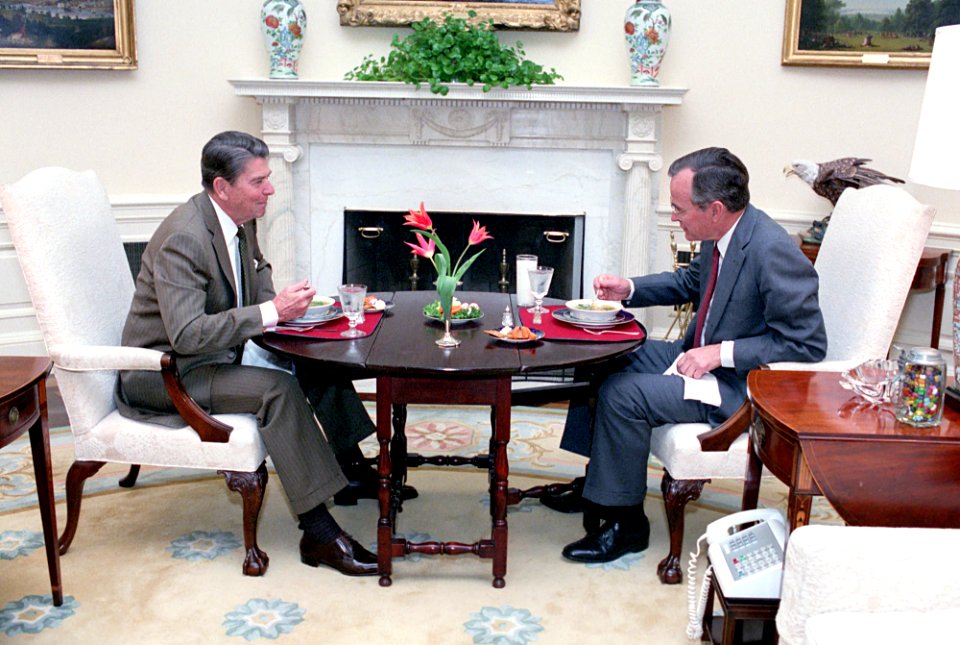 President Ronald Reagan having lunch with George H. W. Bush in the Oval Office