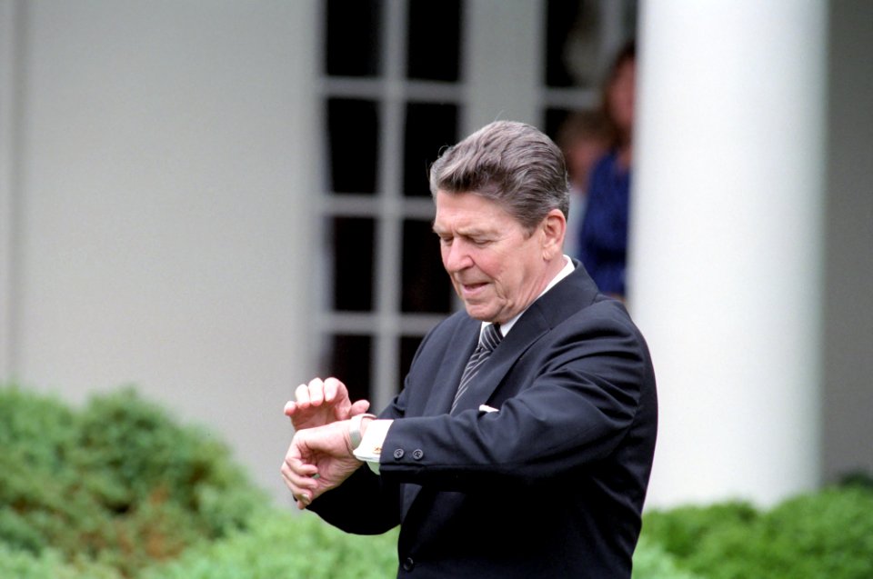 President Ronald Reagan looking at his watch in the Rose Garden