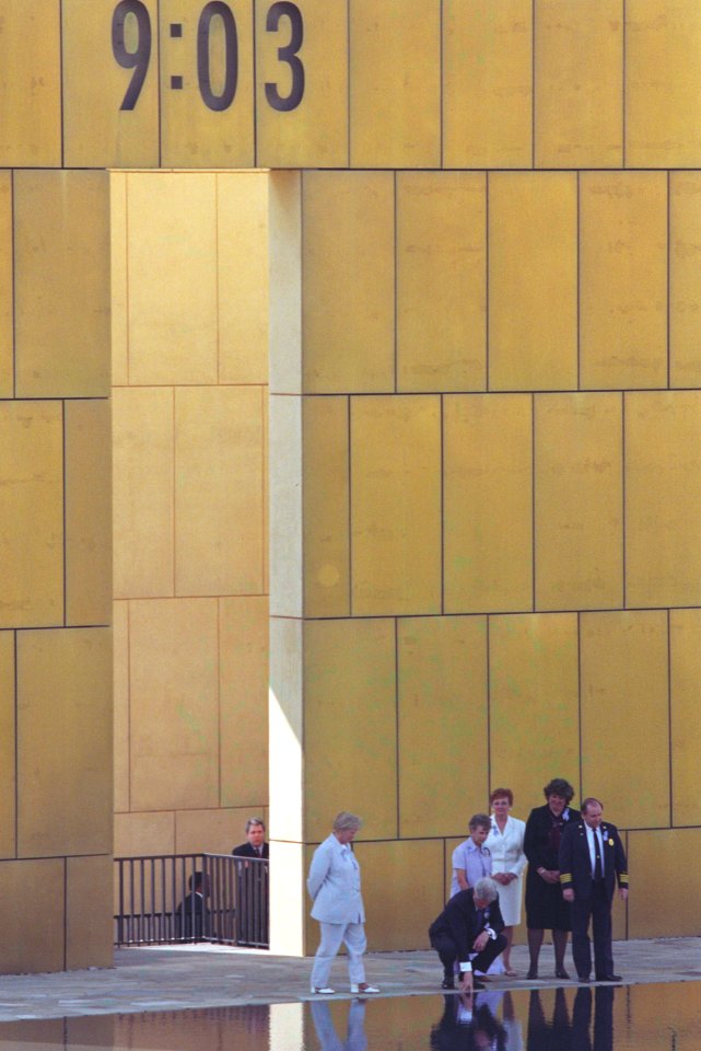 President Bill Clinton touches the water at the dedication of the Oklahoma City National Memorial