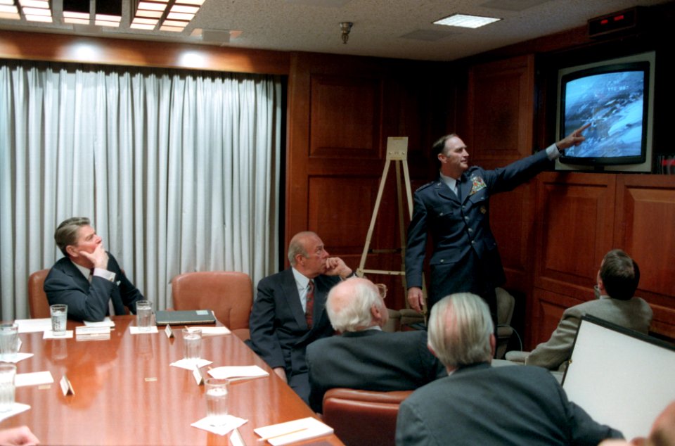 President Ronald Reagan being briefed by the National Security Council staff