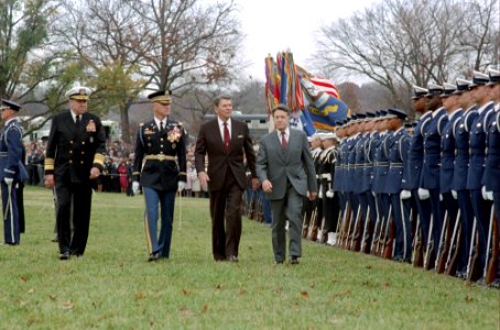 President Ronald Reagan attending a farewell ceremony for retiring Secretary of Defense Caspar Weinberger at the Pentagon with William Crowe