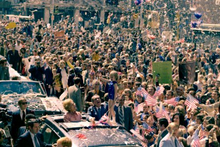 President Richard Nixon and Pat Nixon Stand and Wave to a Crowd in Atlanta, Georgia during a Motorcade and President Nixon Steadies a Child Majorette