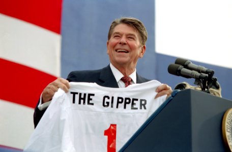 President Ronald Reagan holding The Gipper jersey at a campaign rally in Endicott, New York