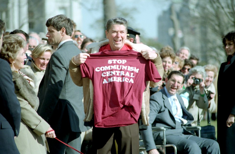 President Ronald Reagan holding a Stop Communism T-Shirt