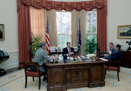President Ronald Reagan in the Oval Office meeting with Ed Meese, Michael Deaver, and James Baker photo