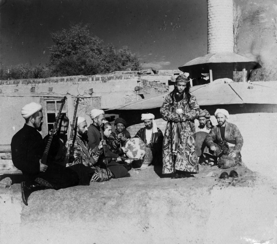 Samarkand A group of musicians playing for a bacha dancing boy