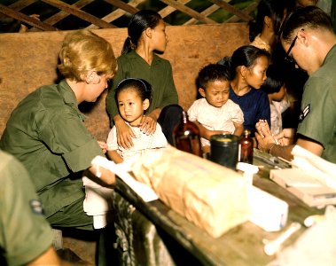 Second Lieutenant Kathleen M. Sullivan treats a Vietnamese child during Operation MED CAP, a U.S. Air Force civic... - NARA - 542331