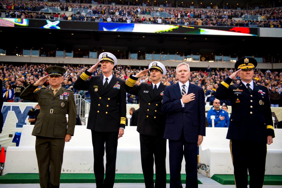 SECNAV and the CNO render honors during the national anthem.