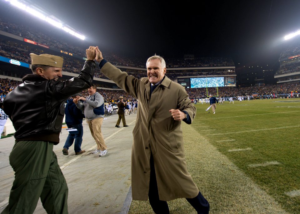 SECNAV Ray Mabus high fives an officer.
