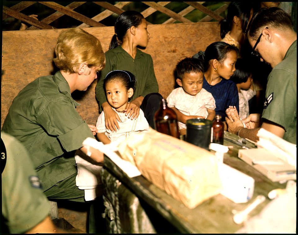 Second Lieutenant Kathleen M. Sullivan treats a Vietnamese child during Operation MED CAP, a U.S. Air Force civic... - NARA - 542331