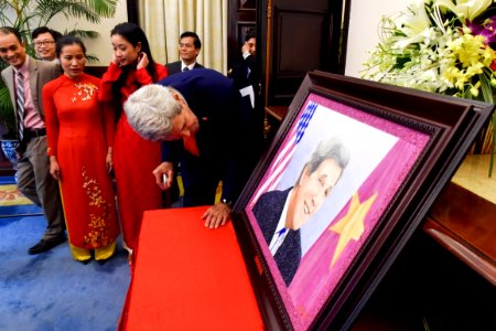 Secretary Kerry Examines a Portait Made to Commemorate the 20th Anniversary of the Normalization of Diplomatic Relations Between the U.S. and Vietnam photo