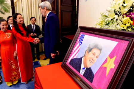 Secretary Kerry Thanks a Vietnamese Artist, Who Studied in Boston, for Making Him a Portrait photo