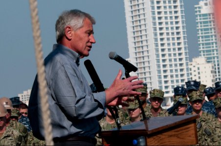 Secretary of Defense Chuck Hagel, at lectern, speaks to troops and merchant mariners aboard the afloat forward staging base USS Ponce (AFSB(I) 15) in Bahrain Dec. 6, 2013 131206-N-IZ292-170