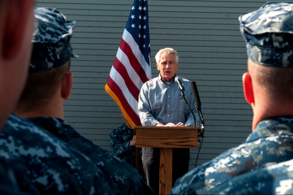 Secretary of Defense Chuck Hagel, at lectern, speaks to troops and merchant mariners aboard the afloat forward staging base USS Ponce (AFSB(I) 15) in Bahrain Dec. 6, 2013 131206-N-IZ292-094