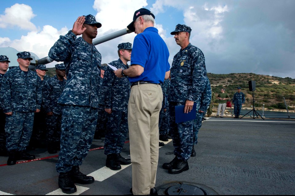 Secretary of the Navy Ray Mabus administers the oath of enlistment to U.S. Navy Quartermaster 3rd Class Nicholas Easter during a re-enlistment ceremony aboard the guided missile destroyer USS Ramage (DDG 61) 131115-N-VC236-046