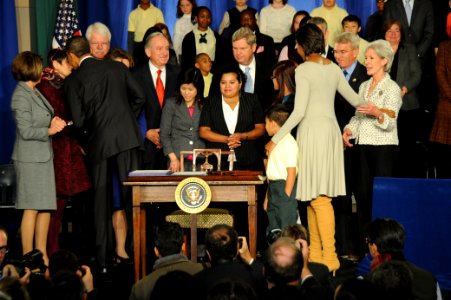 Secretary Sebelius congratulates the First Lady at the signing of the Healthy, Hunger-Free Kids Act of 2010