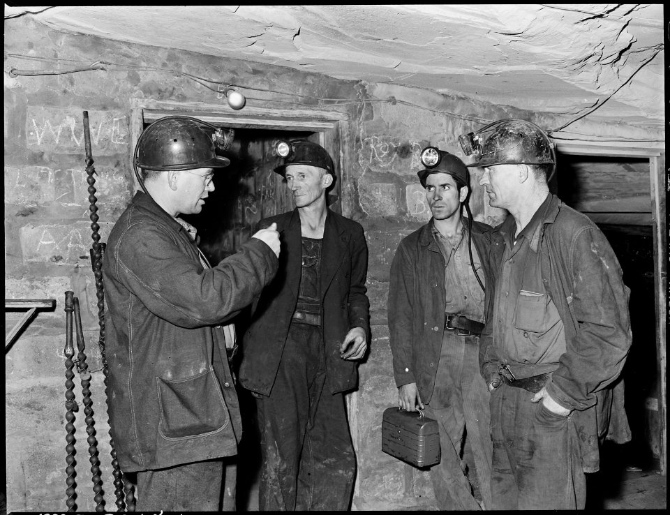 Section foreman, left, gives instructions to miners at last station. Harry Fain, coal loader, is second from left.... - NARA - 541479
