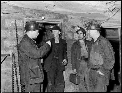 Section foreman, left, gives instructions to miners at last station. Harry Fain, coal loader, is second from left.... - NARA - 541479